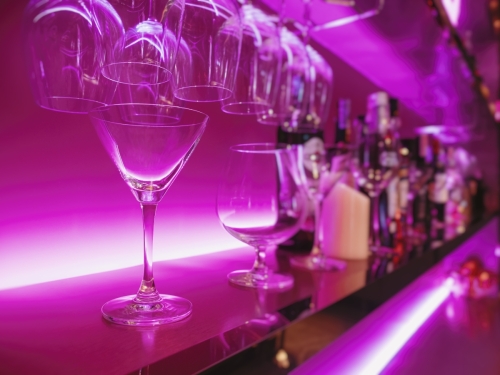 Cocktail Glass on Bar shelf drink Party nightclub blur backgroun